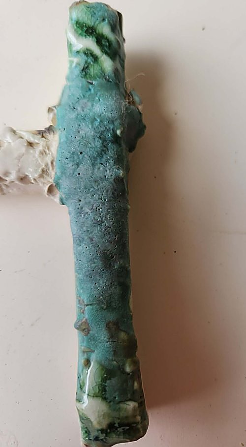A tall test tile glazed overall in Weathered Green, the top layered with Selsor White and clear glaze taken over both ends — a soft blue-green body deepening to dark marbled green at the top edge and warm gold at the foot, on Sculptural Clays (fine)