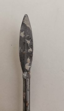 A sculpture eye tool — a small leaf-shaped steel blade on a slim wooden handle