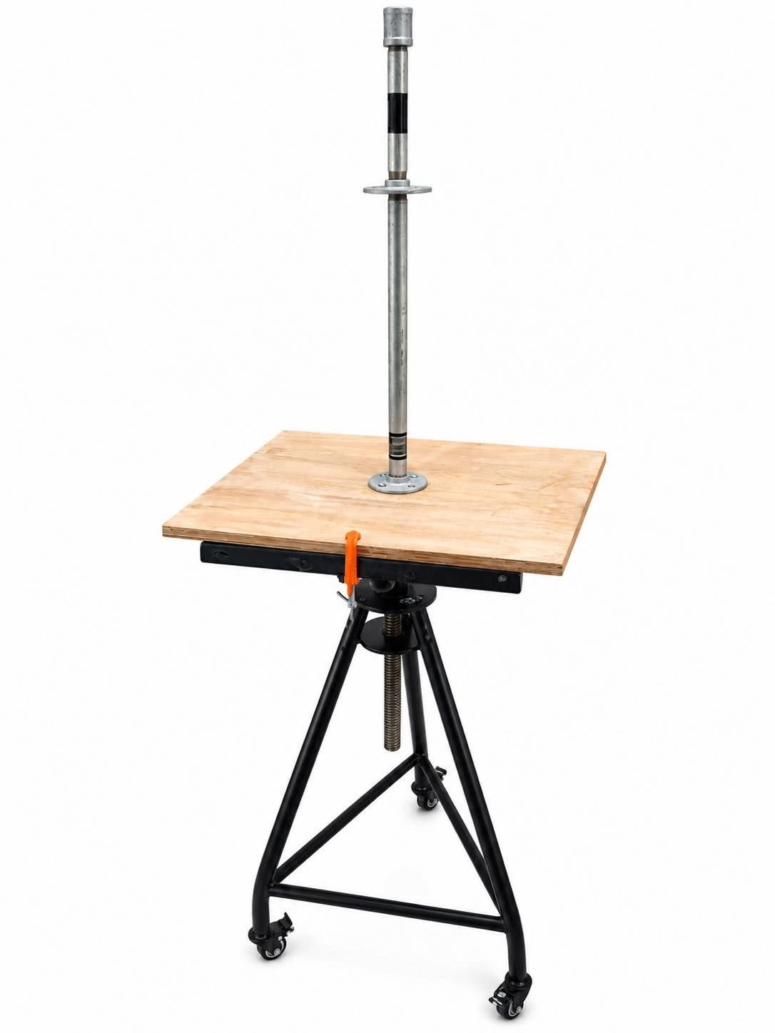A height-adjustable sculpture turntable &mdash; a black steel tripod on lockable castors with a screw column and clamp, a square plywood board bolted on top, and a galvanised steel armature rod rising from a flange fixed through the centre of the board
